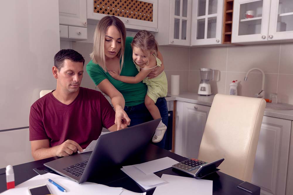 Young family looking at a laptop
