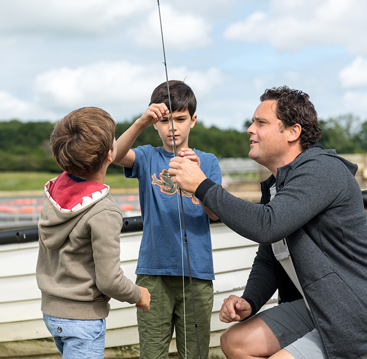 Father fishing with his two sons