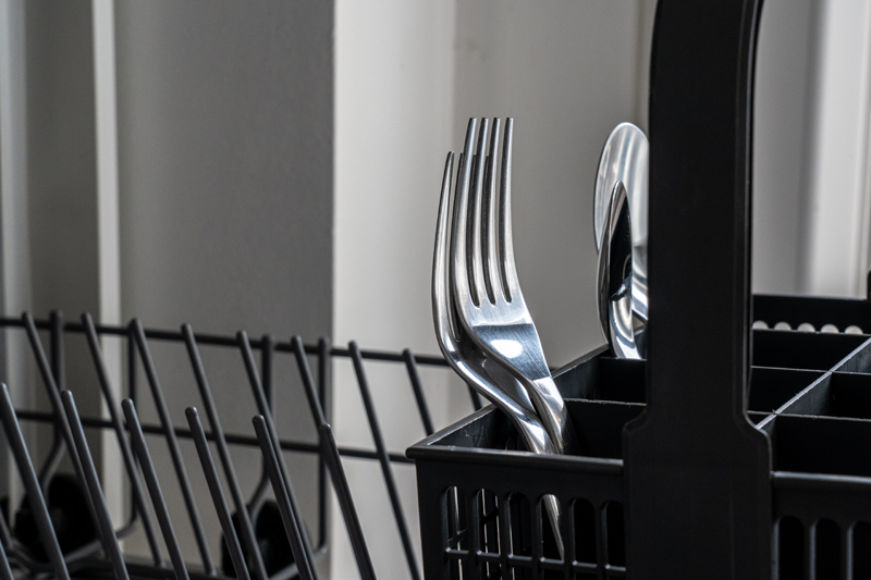 Cutlery being loaded into a fishwasher