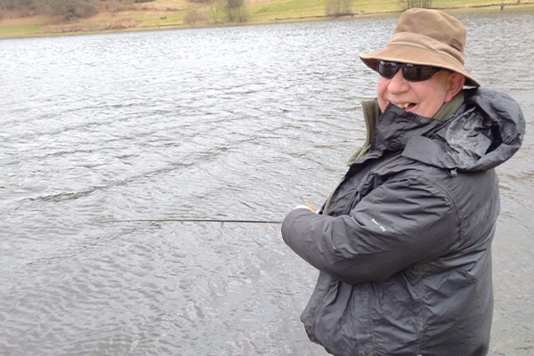 Man stood up fishing at Clatworthy Reservoir