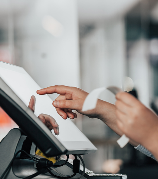 Someone at a till holding a receipt