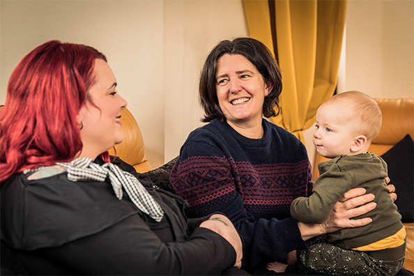 Couple Smiling With a Baby