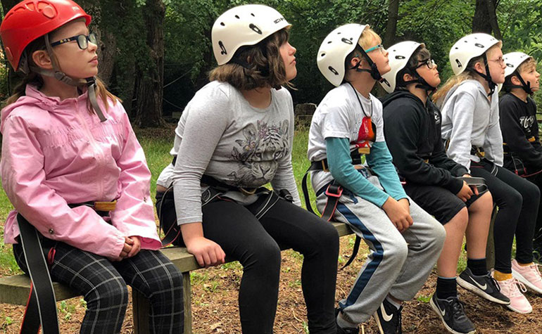 Young carers getting ready to climb at Burnbake Ropes Course in Dorset